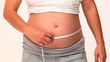 Pregnant woman with a measuring tape