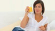Video: Cute brunette woman drinking a glass of orange juice Cute brunette woman drinking a glass of orange juice