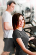 Beautiful girl running on a treadmill in sport club Beautiful girl running on a treadmill in sport club