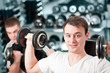 Two guys lifting weight in sportclub Two guys lifting weight in sportclub