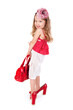 Funny little girl trying on her mother's shoes
