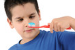 Photo: Cross eyed boy brushing teeth isolated on white background. Cross eyed boy brushing teeth isolated on white background.
