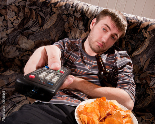 Photo: Sleepy man watching TV Sleepy man watching TV