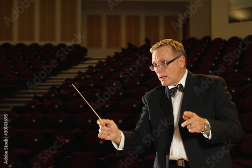 Photo: Male symphony conductor in action Male symphony conductor in action