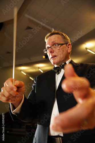 Photo: Male symphony conductor in action Male symphony conductor in action