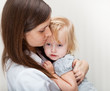 a mother is holding a sick girl.