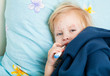 a sick girl is measuring the temperature