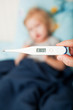 a mother measures the temperature of her daughter