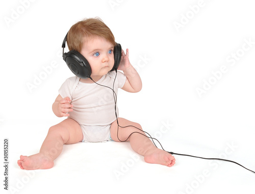 Foto: Young Baby Listening to Music Headphones Young Baby Listening to Music Headphones