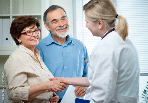 Photo: senior couple visiting a doctor senior couple visiting a doctor
