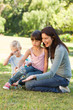 Family blowing bubbles in the park