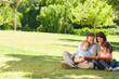 Family looking at their photo album in the park