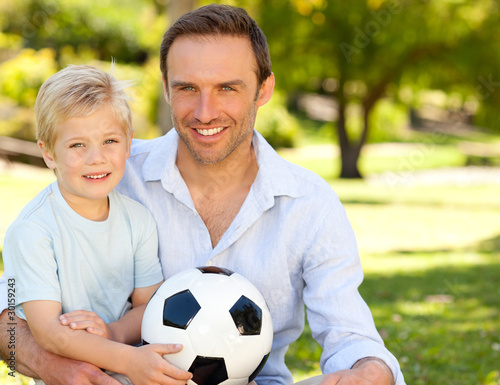 Photo: Father with his son after a football game Father with his son after a football game