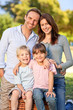 Photo: Smiling family picnicking in the park Smiling family picnicking in the park