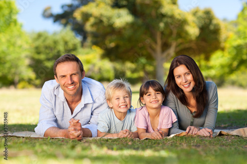 Photo: Family lying down in the park Family lying down in the park