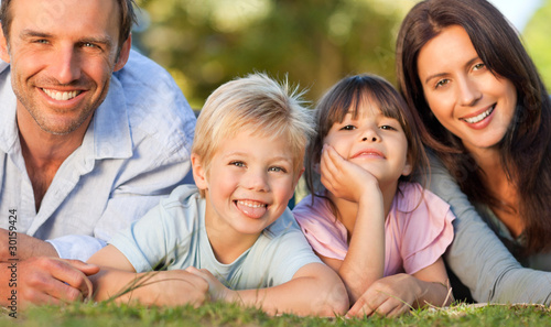 Photo: Family lying down in the park Family lying down in the park