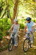 Elderly couple mountain biking outside