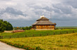 wooden cottage on green hill