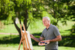 Senior man painting in the garden Senior man painting in the garden