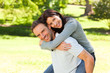 Man giving wife a piggyback