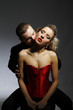 man kissing woman in her neck