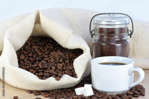 Photo: Hot coffee, beans and sugar cubes. Hot coffee, beans and sugar cubes.