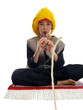 boy playing the flute charming a rope