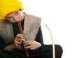 boy playing the flute charming a rope