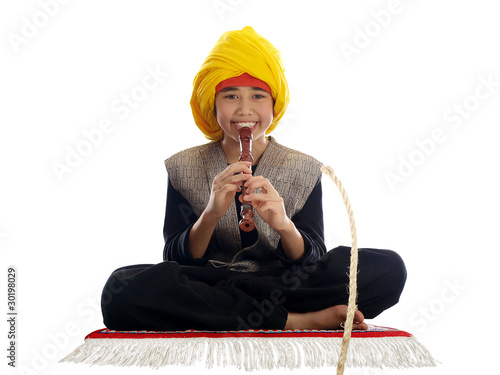 Photo: boy playing the flute charming a rope boy playing the flute charming a rope