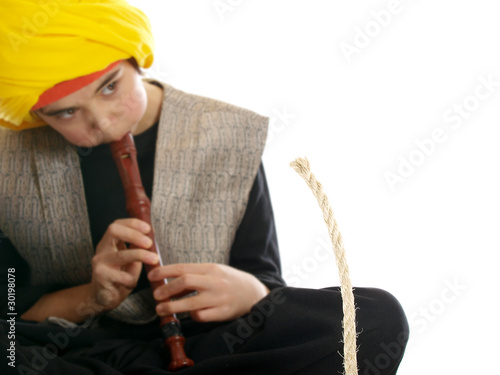 Photo: boy playing the flute charming a rope boy playing the flute charming a rope
