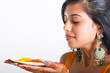 indian woman smelling spices