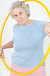 senior lady doing gymnastic with hula-hoop