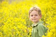 Young Boy in a Field of Yellow Flowers
