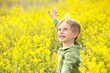 Young Boy in a Field of Yellow Flowers