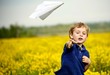 Boy Flying a Paper Airplane