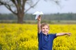 Boy Flying a Paper Airplane