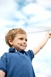 Boy Flying a Paper Airplane
