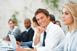 Executive smiling during seminar