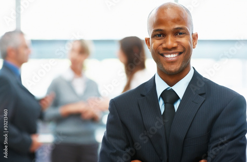 Photo: Happy executive with arms folded Happy executive with arms folded