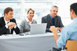 Business people interviewing a man Business people interviewing a man