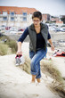 Photo: Young woman climbing a sand dune Young woman climbing a sand dune