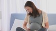 Pregnant woman stroking her belly