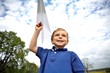 Boy Flying a Paper Airplane