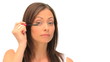 Coquette brunette putting on make-up