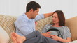 Young couple letting their future baby listening to music