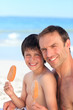 Father eating an ice cream with his son