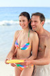 Couple playing frisbee