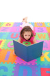 Girl reading book on alphabet floor mat Girl reading book on alphabet floor mat