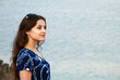 The portrait of beautiful girl looking at sea