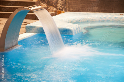 Photo: Empty Spa pool with waterfall jet and jacuzzy in action Empty Spa pool with waterfall jet and jacuzzy in action